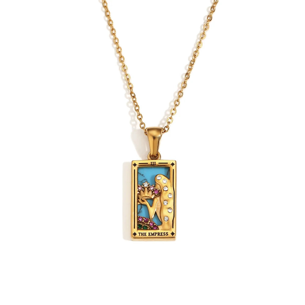 Gold-tone The Empress tarot card pendant necklace with blue enamel and pink stones, on white