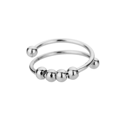 Silver-tone open spinner ring with four sliding beads and ball ends, on white