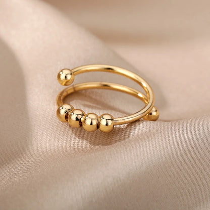 Gold spinner ring with beads, close-up