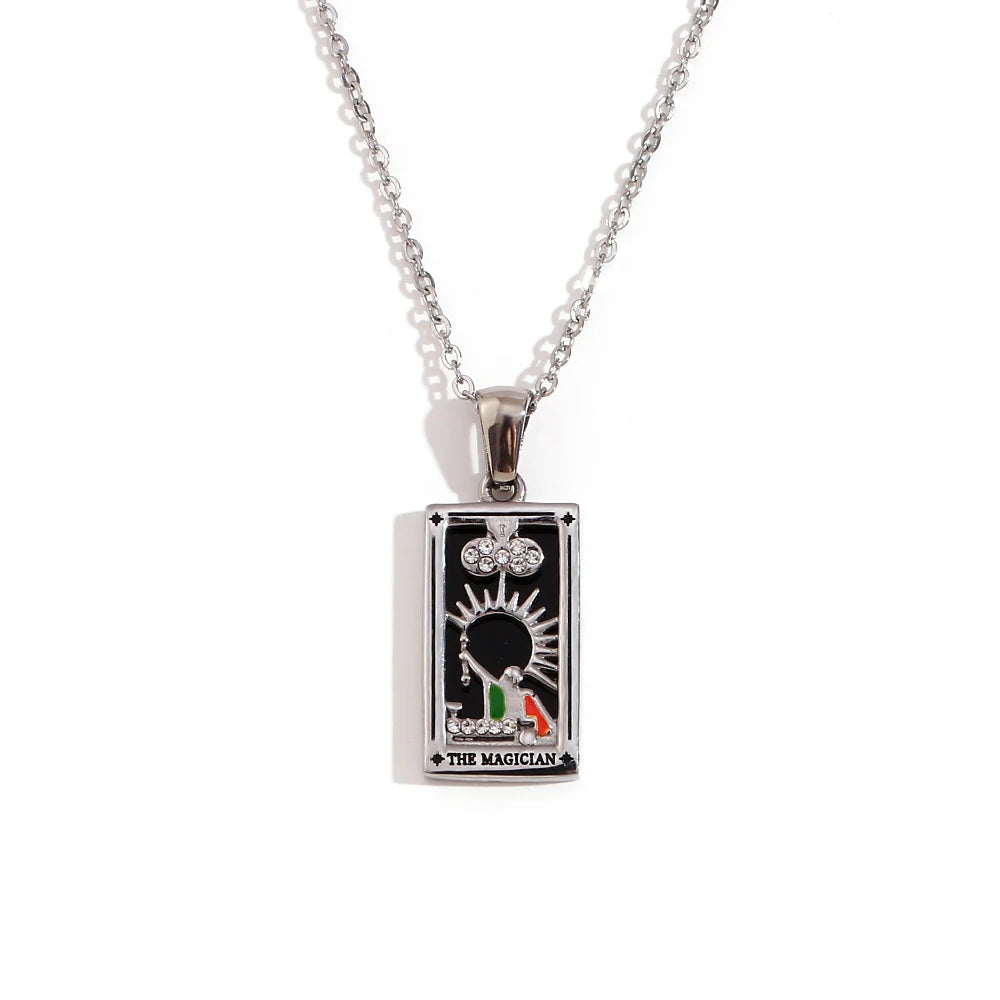 Silver-tone The Magician tarot card pendant necklace with black enamel and coloured detail, on white