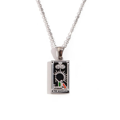 Silver-tone The Magician tarot card pendant necklace with black enamel and coloured detail, on white