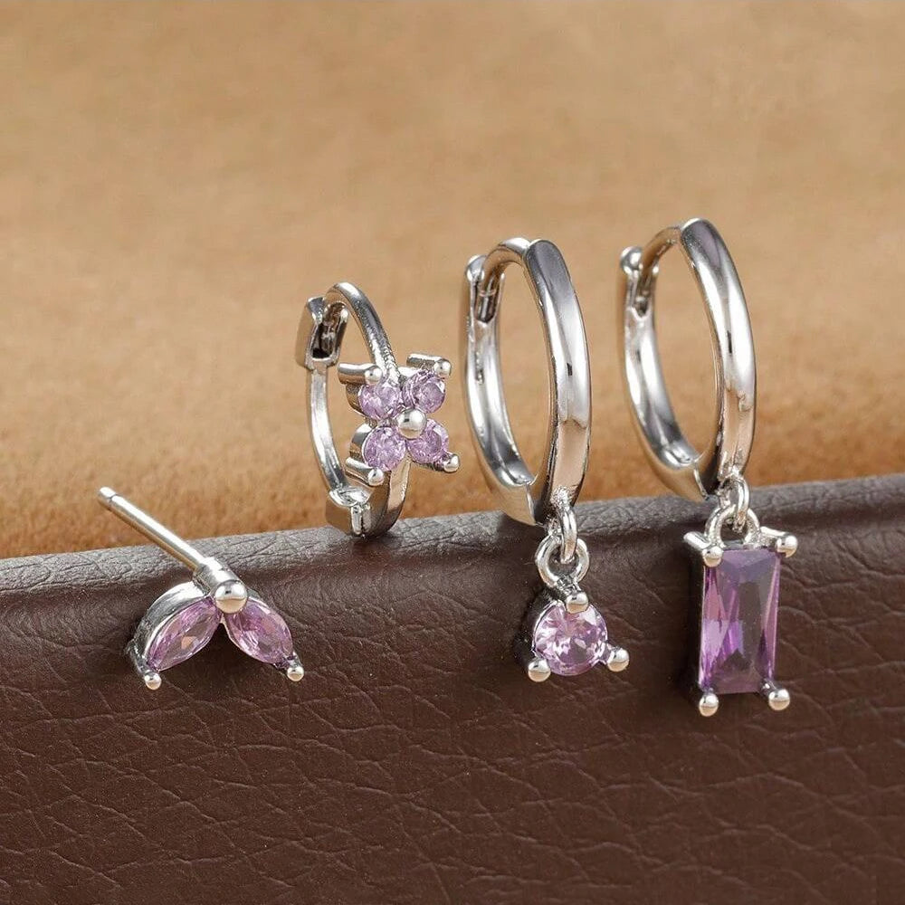 Silver-tone four-piece ear stack with lilac stones: leaf stud, flower huggie, round drop hoop and baguette drop hoop