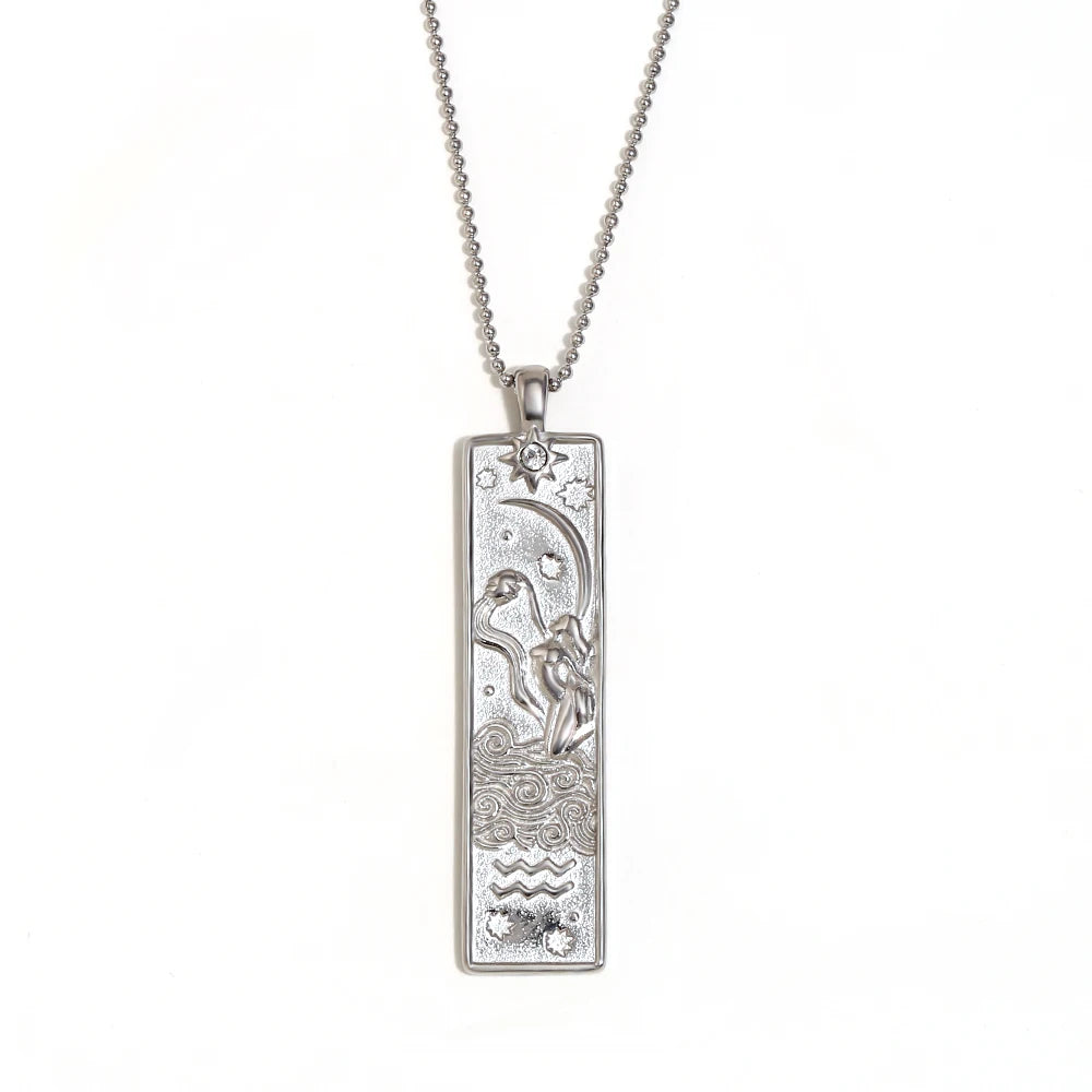 Silver-tone Aquarius zodiac bar pendant necklace with engraved water bearer and a small clear stone, on white