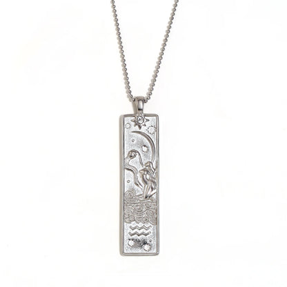 Silver-tone Aquarius zodiac bar pendant necklace with engraved water bearer and a small clear stone, on white