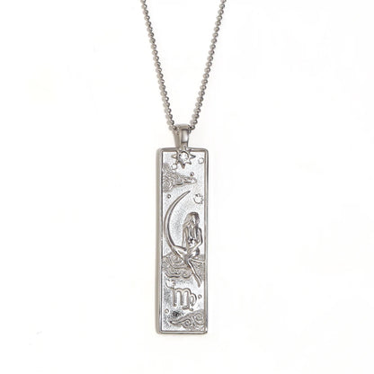 Silver-tone Virgo zodiac bar pendant necklace with engraved maiden and moon, and a small clear stone, on white