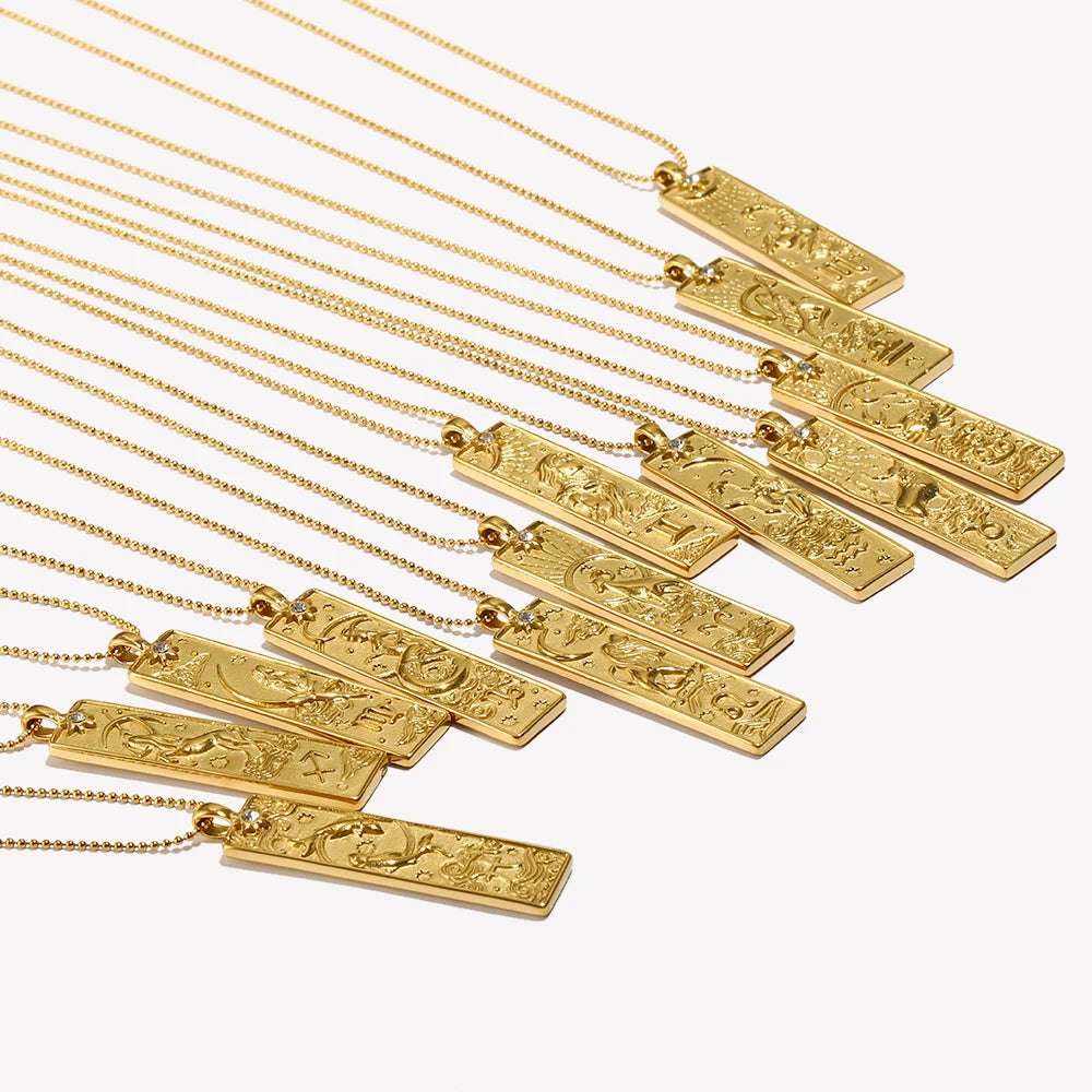 Gold zodiac star sign pendant necklaces in a row