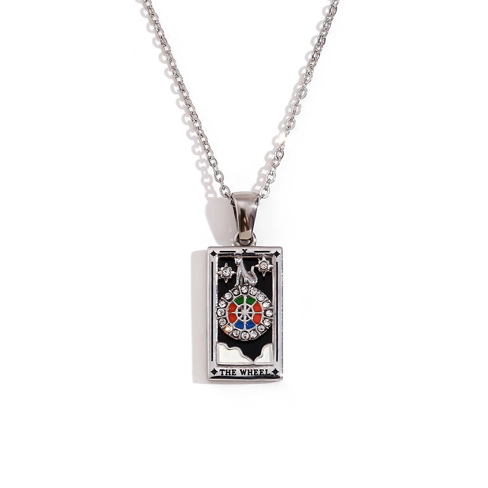 Silver-tone Wheel of Fortune tarot card pendant necklace with black enamel and coloured stones, on white