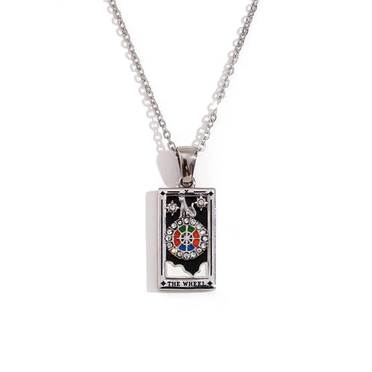 Silver-tone Wheel of Fortune tarot card pendant necklace with black enamel and coloured stones, on white