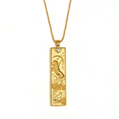 Gold-tone Sagittarius zodiac bar pendant necklace with engraved archer and a small clear stone, on white