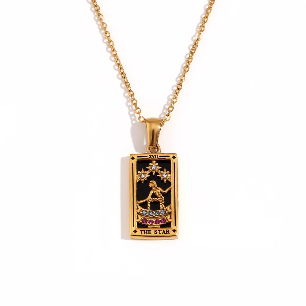 Gold-tone The Star tarot card pendant necklace with black enamel, clear and pink stones, on white