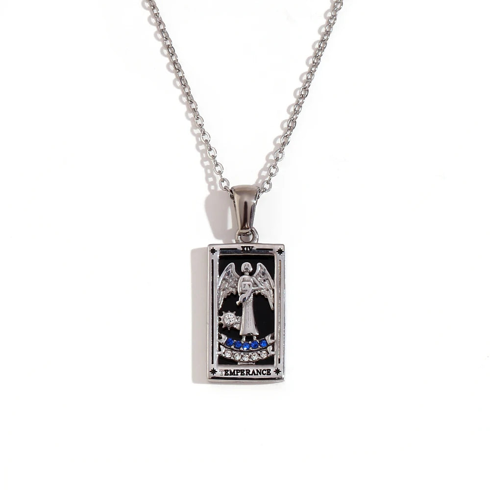 Silver-tone Temperance tarot card pendant necklace with angel design, black enamel and blue stones, on white