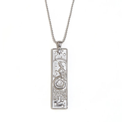 Silver-tone Capricorn zodiac bar pendant necklace with engraved sea-goat and a small clear stone, on white