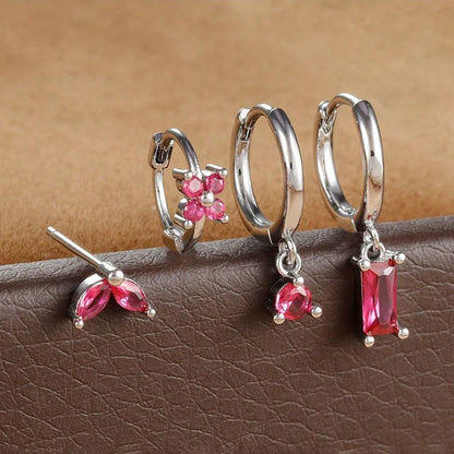 Silver-tone four-piece ear stack with pink stones: leaf stud, flower huggie, round drop hoop and baguette drop hoop