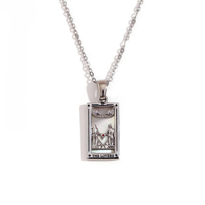 Silver-tone The Lovers tarot card pendant necklace with cut-out figures and small clear stones, on white