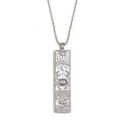 Silver-tone Cancer zodiac bar pendant necklace with engraved crab and a small clear stone, on white