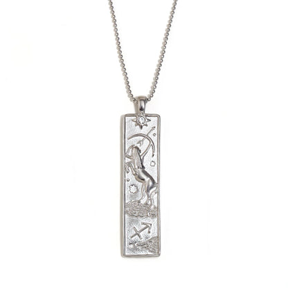 Silver-tone Sagittarius zodiac bar pendant necklace with engraved archer and a small clear stone, on white