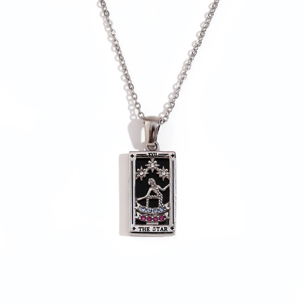 Silver-tone The Star tarot card pendant necklace with black enamel, clear and pink stones, on white
