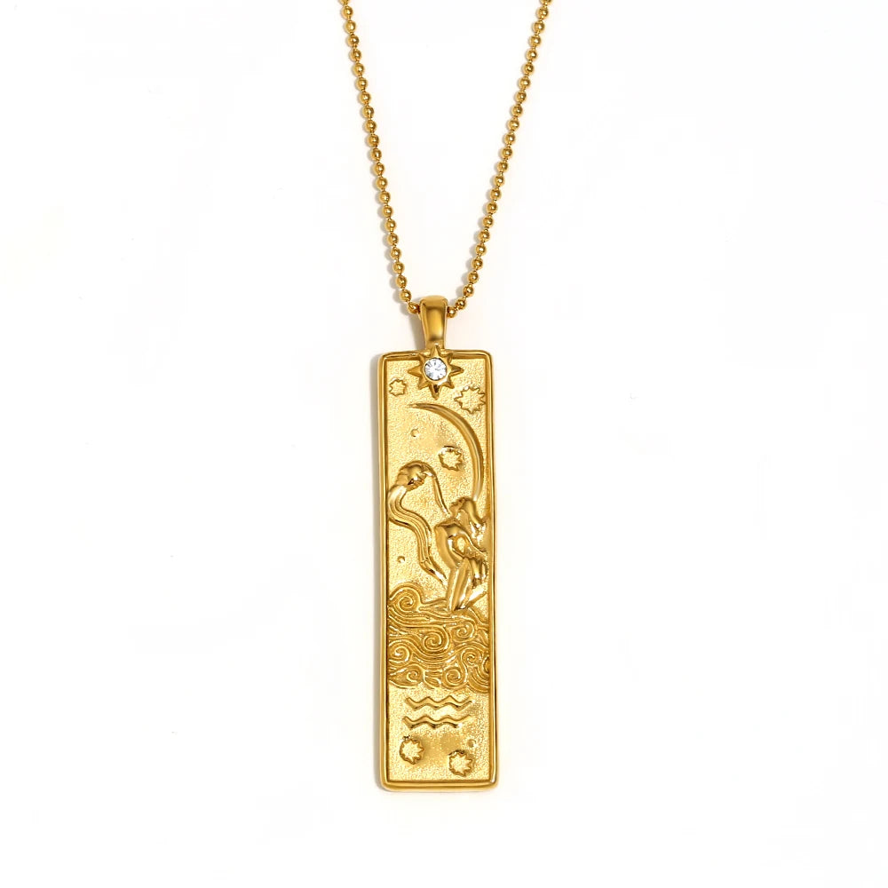 Gold-tone Aquarius zodiac bar pendant necklace with engraved water bearer and a small clear stone, on white