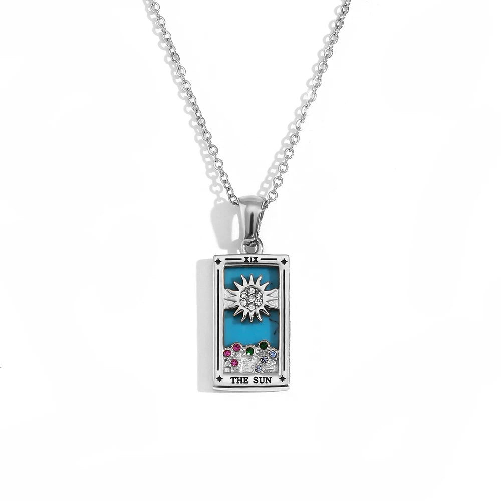 Silver-tone The Sun tarot card pendant necklace with blue enamel, clear and coloured stones, on white