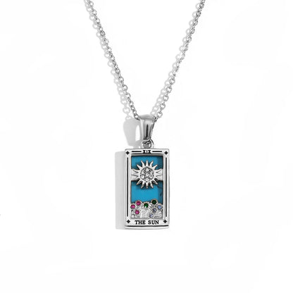 Silver-tone The Sun tarot card pendant necklace with blue enamel, clear and coloured stones, on white